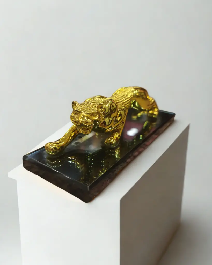 Golden Cheetah on a flat and thick mirror base standing in the hunting position