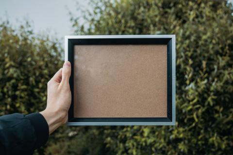 A man holding the frame for walls